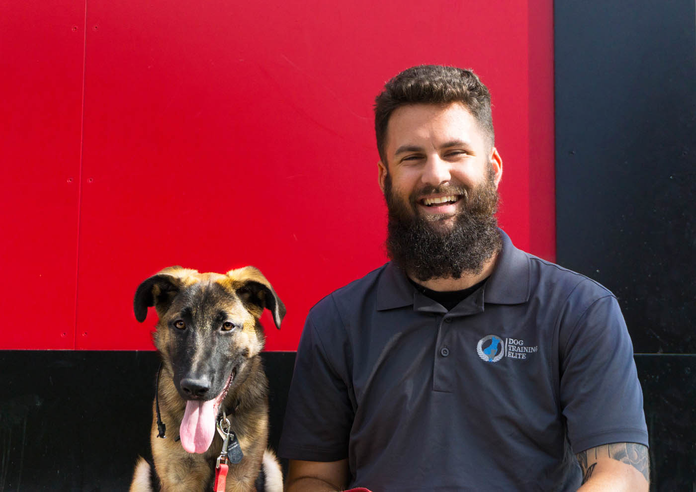 A Dog Training Elite Northern Utah owner smiling with his dog in Davis / Weber County, UT.