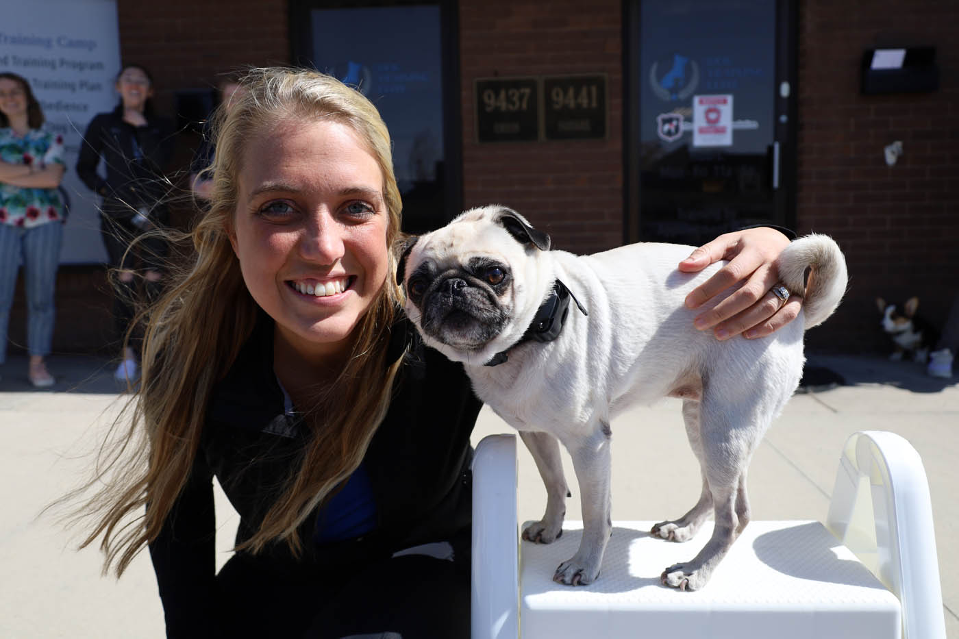 A dog owner with her pug who has received e-collar dog training in Lowell, MA from Dog Training Elite.