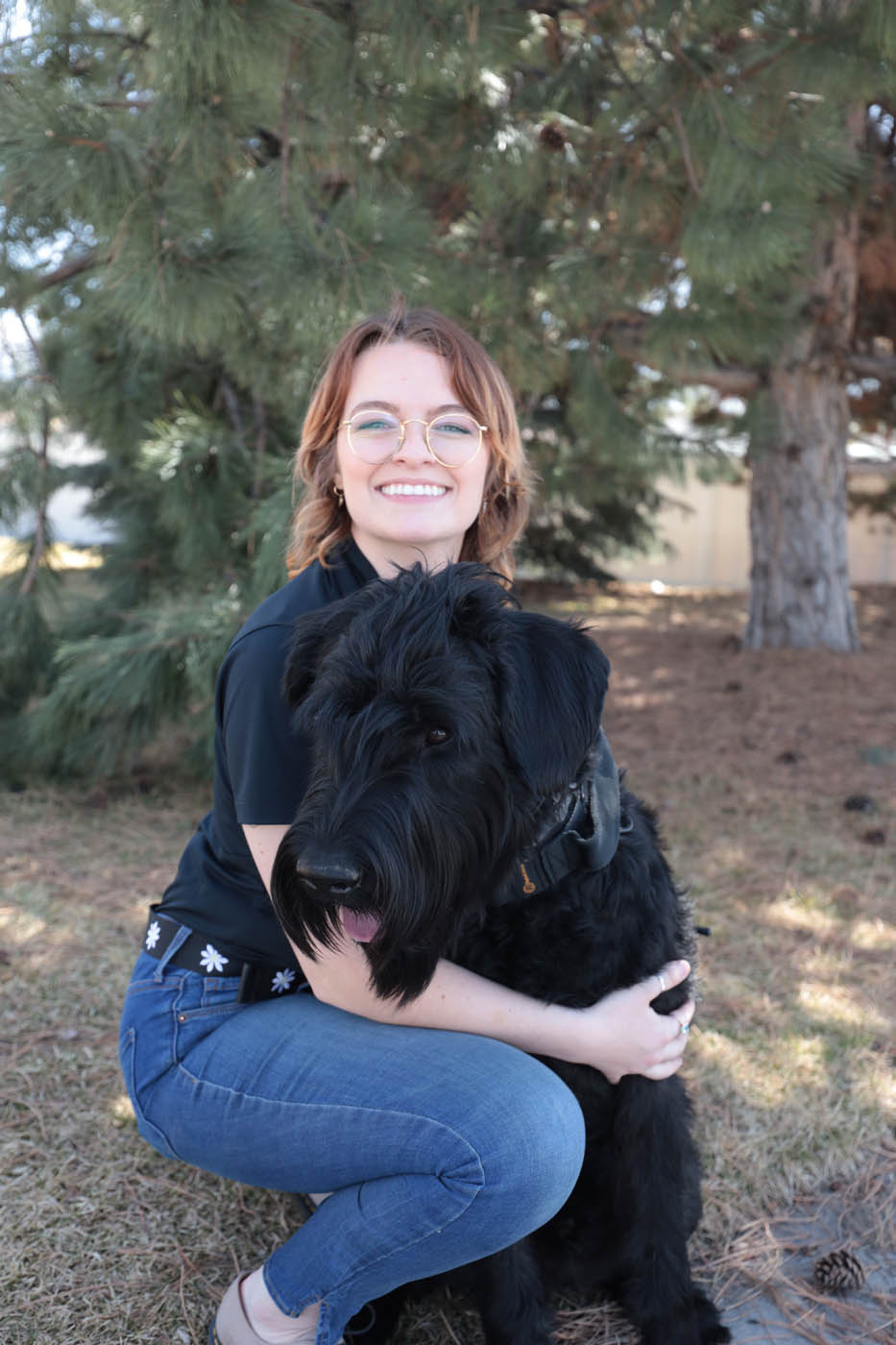 A Dog Training Elite Emerald Coast owner with her black lab dog, our obedience training for dogs in Pensacola, FL can help strengthen your bond.