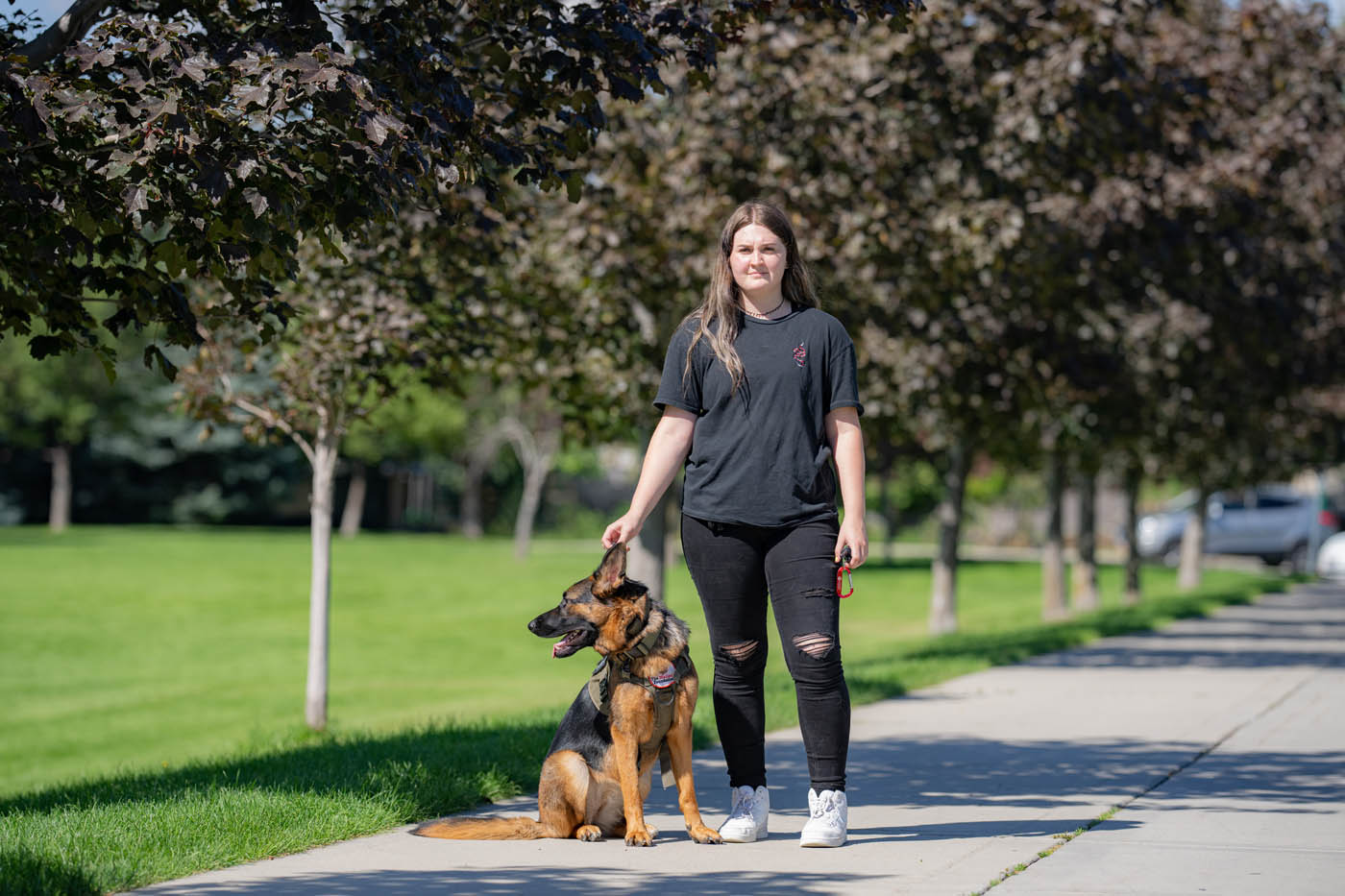 A woman walking with a service dog - Dog Training Elite can train your puppy or dog in Milwaukee, WI.