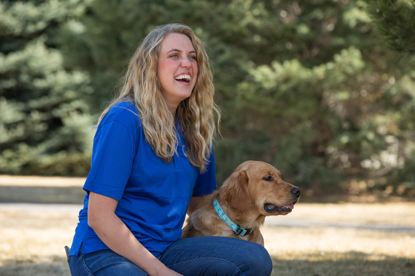 An owner and their happy, healthy dog with expert training from Dog Training Elite Emerald Coast.